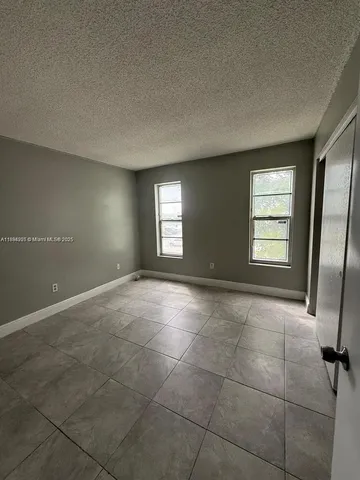 a view of an empty room with windows