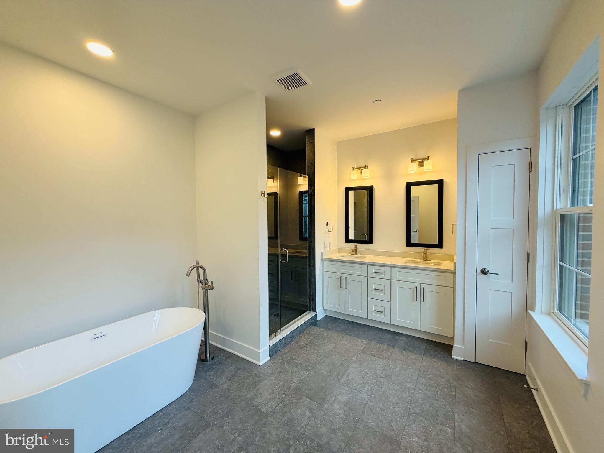 208 2nd Street East, Unit 202 Frederick, MD 21701 - Photo 8 of 9 a large bathroom with a large tub and sink
