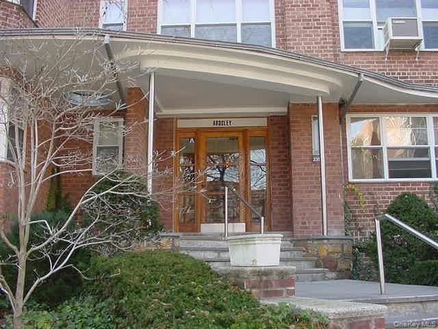 235 Garth Road, Unit A5B Scarsdale, NY 10583 - Photo 3 of 47 a front view of a house with a garden