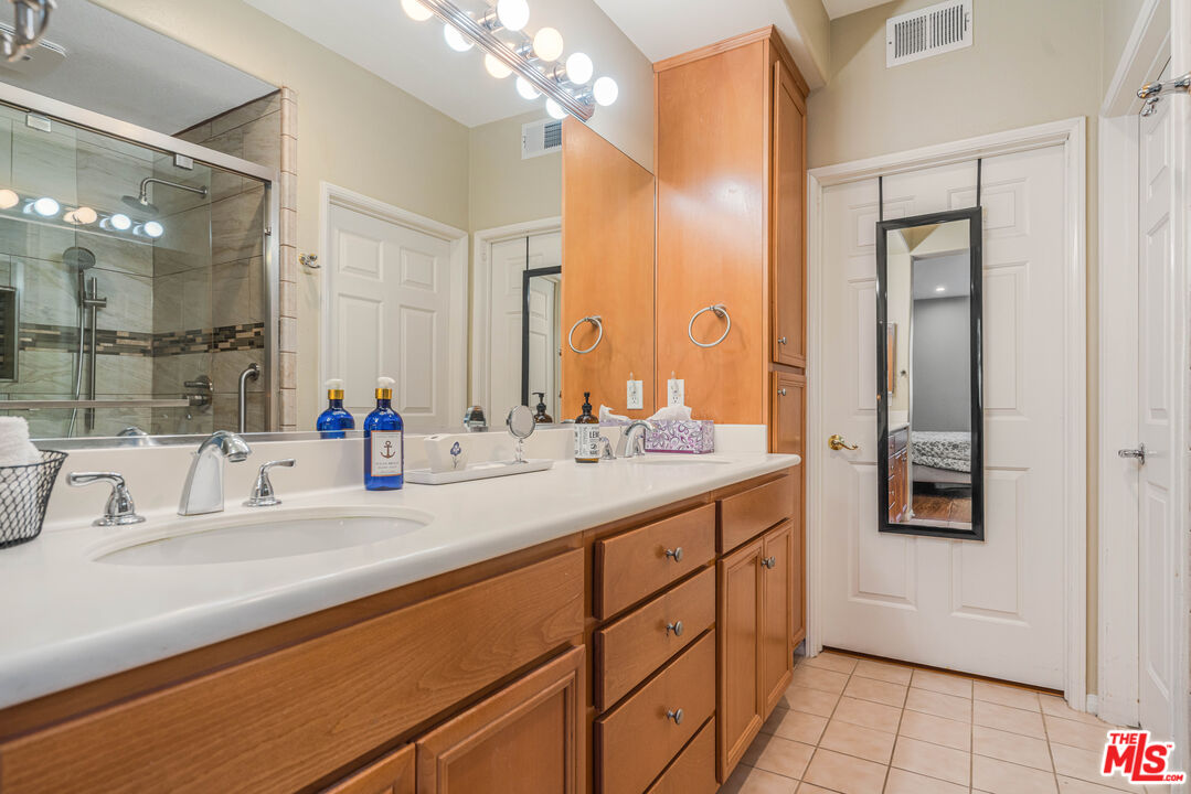 12963 West Runway Road, Unit 221 Playa Vista, CA 90094 - Photo 12 of 17 a bathroom with a sink double vanity and a mirror