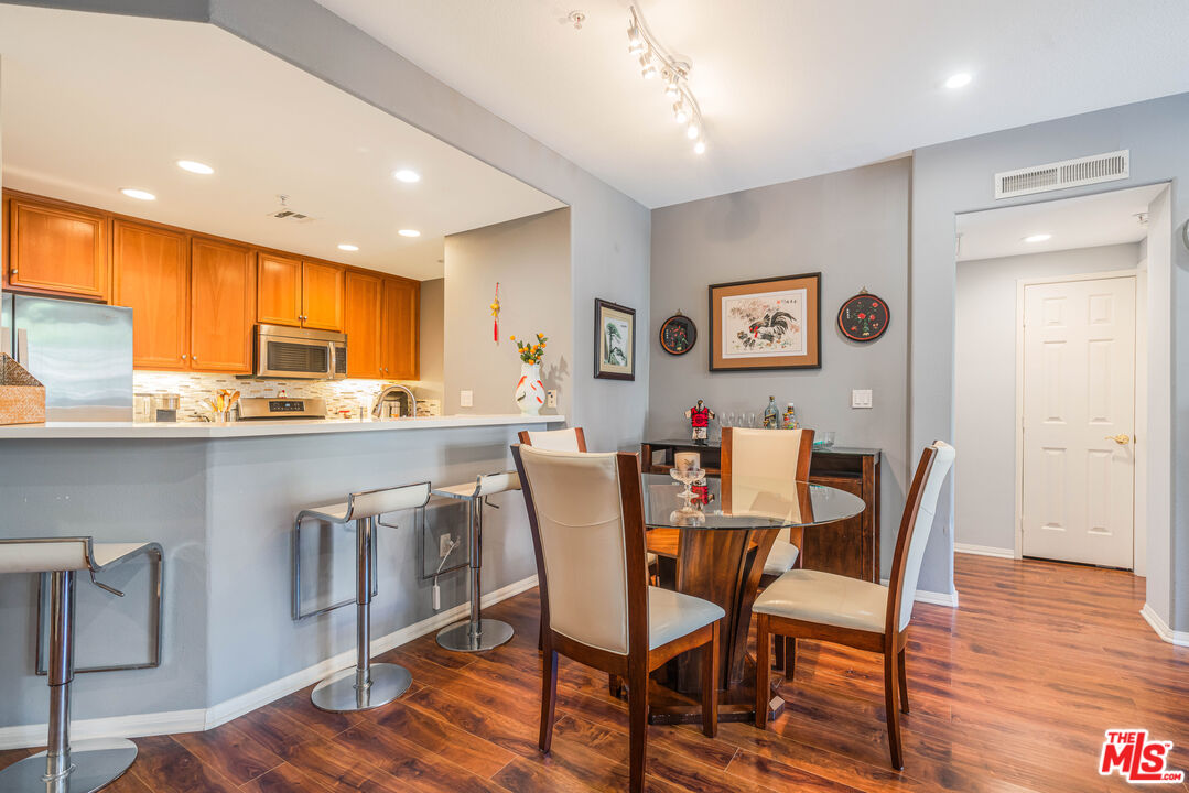 12963 West Runway Road, Unit 221 Playa Vista, CA 90094 - Photo 3 of 17 a view of a dining room with furniture and wooden floor