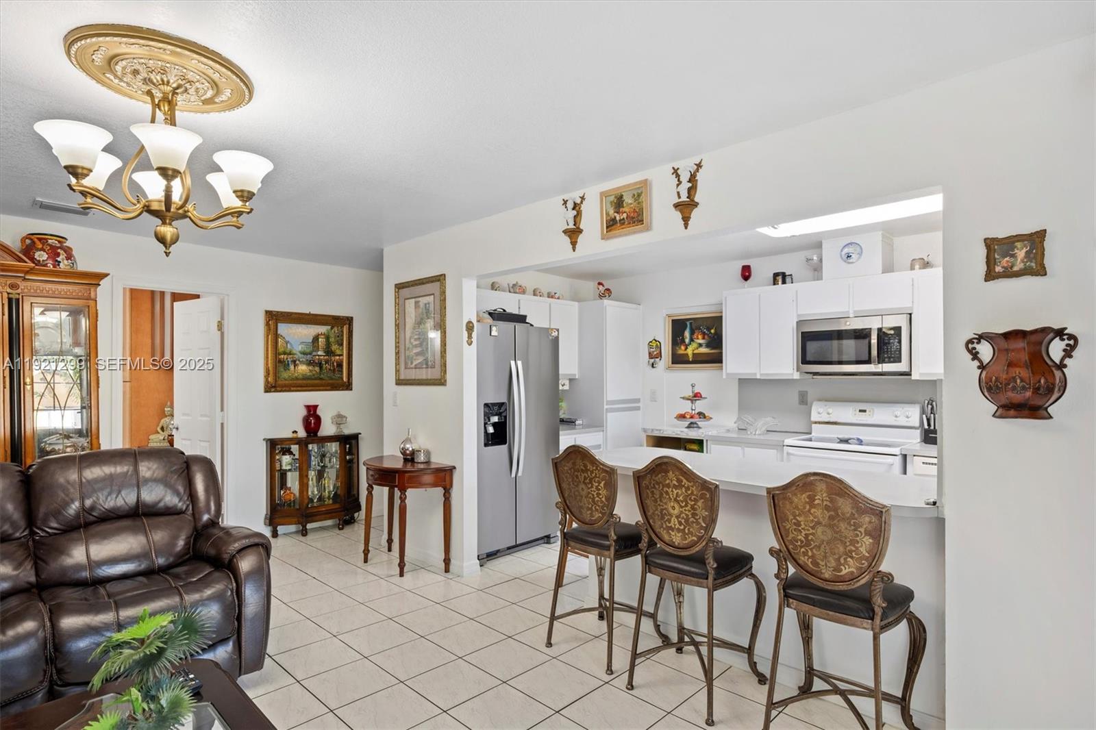 20851 Southwest 242nd Street Homestead, FL 33031 - Photo 12 of 42 a view of a dining room with furniture and chandelier