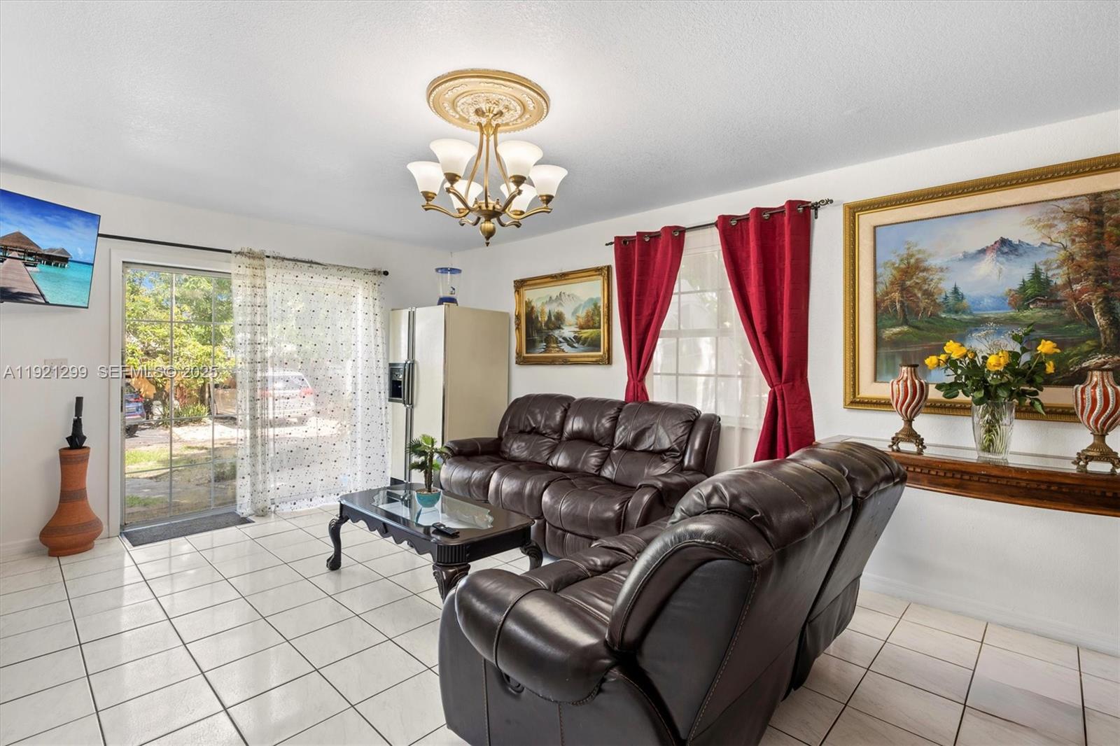 20851 Southwest 242nd Street Homestead, FL 33031 - Photo 15 of 42 a living room with furniture a dining table and a large window