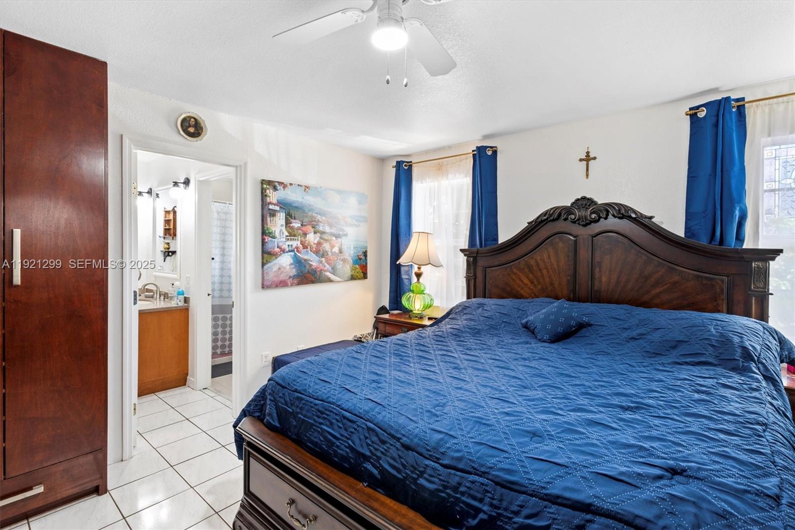20851 Southwest 242nd Street Homestead, FL 33031 - Photo 16 of 42 a bedroom with a bed and a dresser