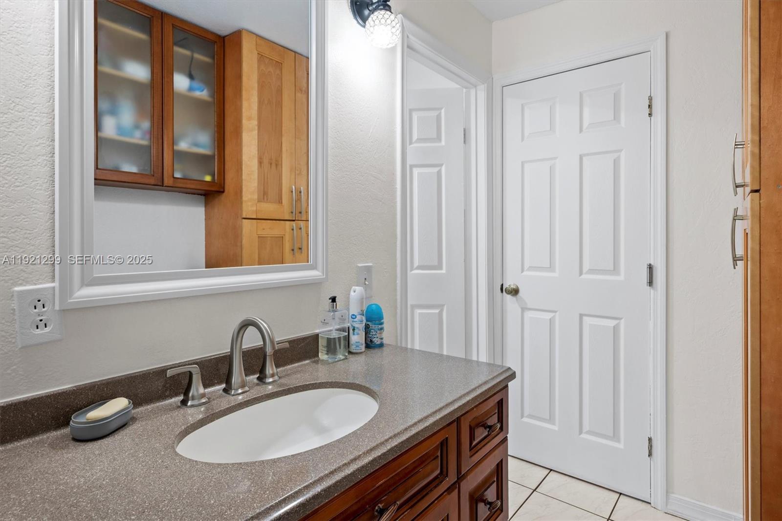 20851 Southwest 242nd Street Homestead, FL 33031 - Photo 18 of 42 a bathroom with a granite countertop sink and a mirror