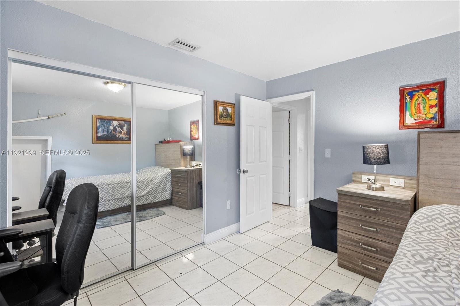 20851 Southwest 242nd Street Homestead, FL 33031 - Photo 20 of 42 a bedroom with furniture and a chair