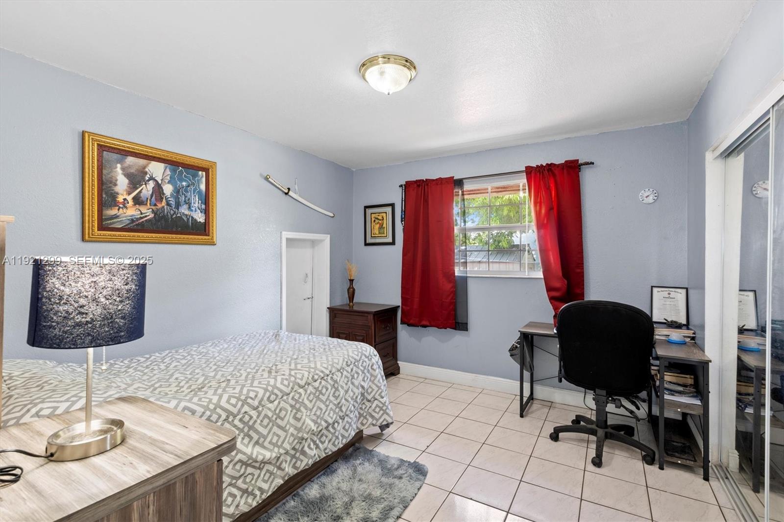 20851 Southwest 242nd Street Homestead, FL 33031 - Photo 21 of 42 a bedroom with a bed and a desk