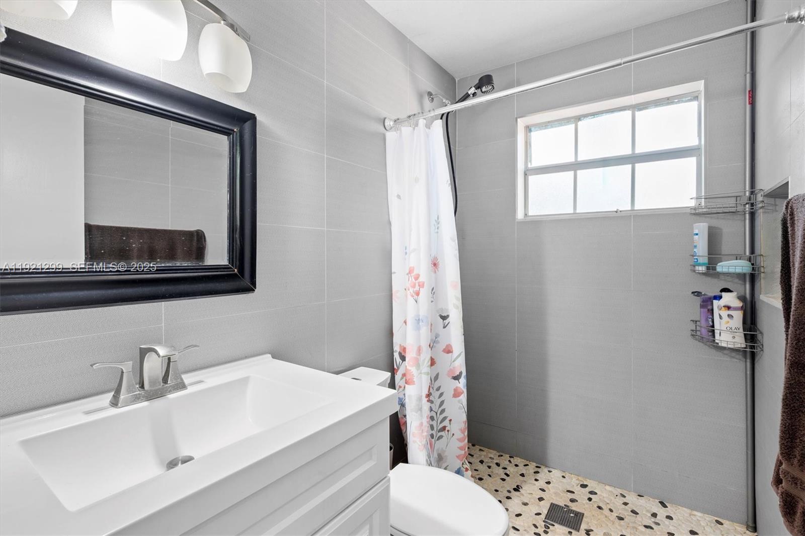 20851 Southwest 242nd Street Homestead, FL 33031 - Photo 22 of 42 a bathroom with a sink toilet and shower