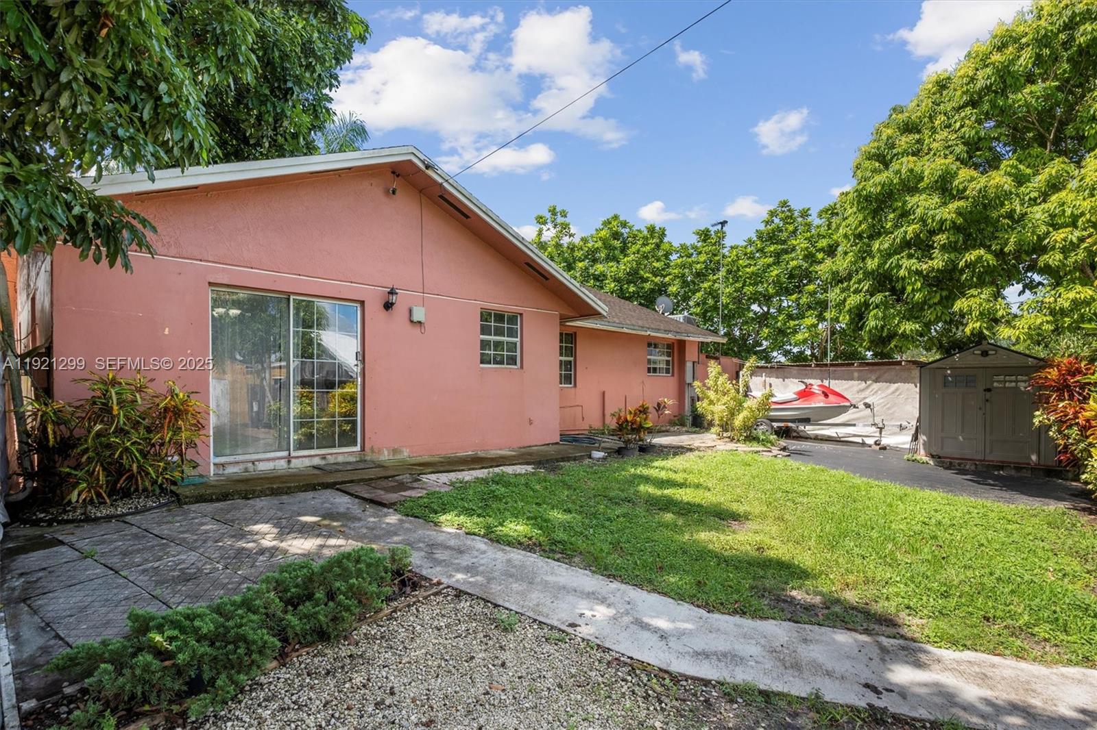 20851 Southwest 242nd Street Homestead, FL 33031 - Photo 25 of 42 a front view of a house with a yard and garage