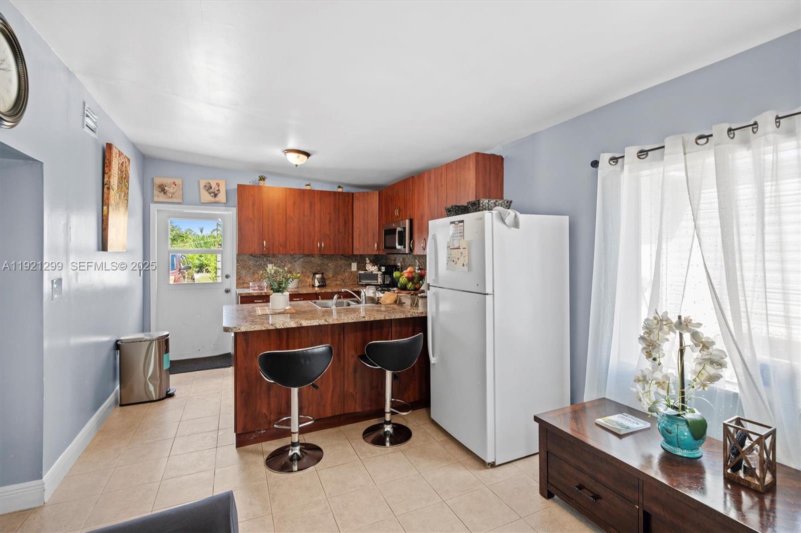 20851 Southwest 242nd Street Homestead, FL 33031 - Photo 28 of 42 a view of kitchen with refrigerator stove and window