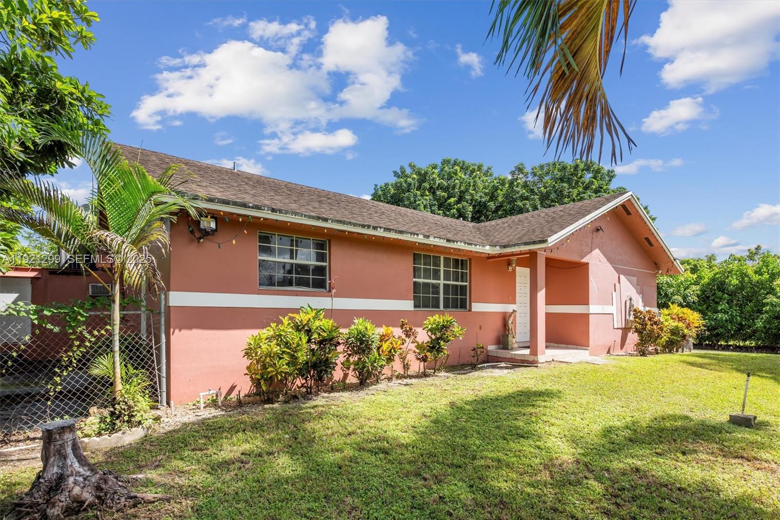 20851 Southwest 242nd Street Homestead, FL 33031 - Photo 4 of 42 a front view of a house with garden