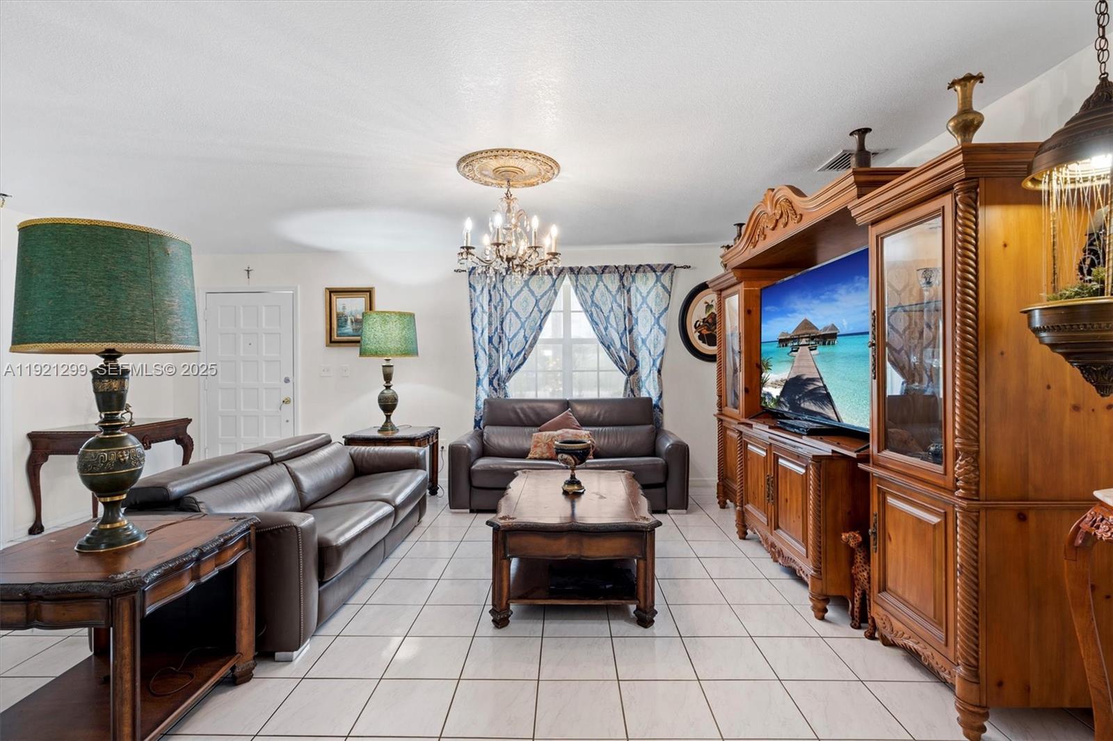 20851 Southwest 242nd Street Homestead, FL 33031 - Photo 7 of 42 a living room with furniture and a flat screen tv