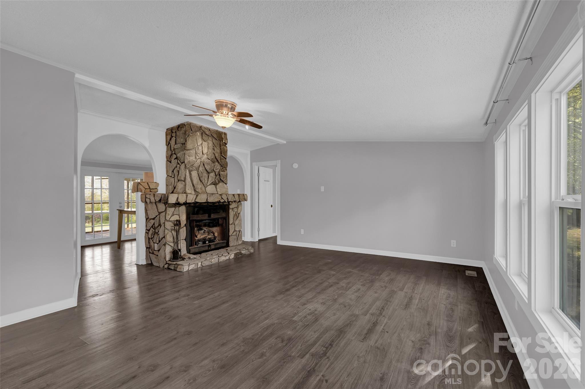 5708 Harwell Road Catawba, NC 28609 - Photo 6 of 31 an empty room with wooden floor fireplace and windows