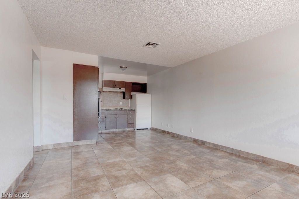 421 North Decatur Boulevard, Unit 2 Las Vegas, NV 89107 - Photo 6 of 21 A compact kitchen with functional appliances and ample open floor space provides a practical living area.