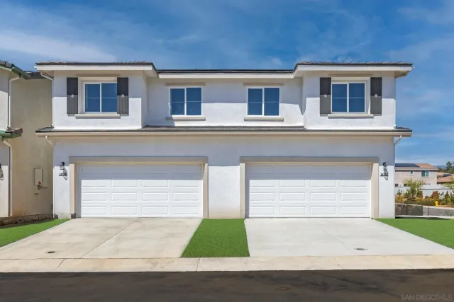 a front view of house with garage