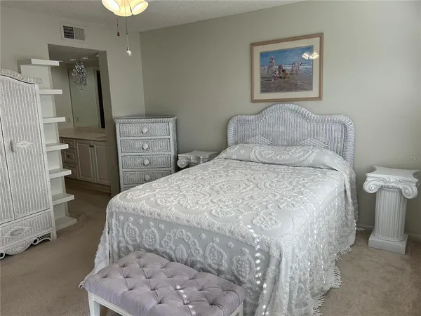 a bed sitting in a bedroom and dresser