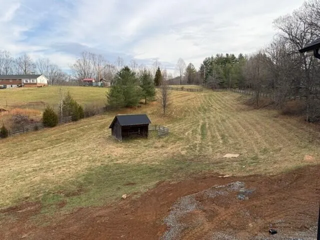 a view of a yard with a tree