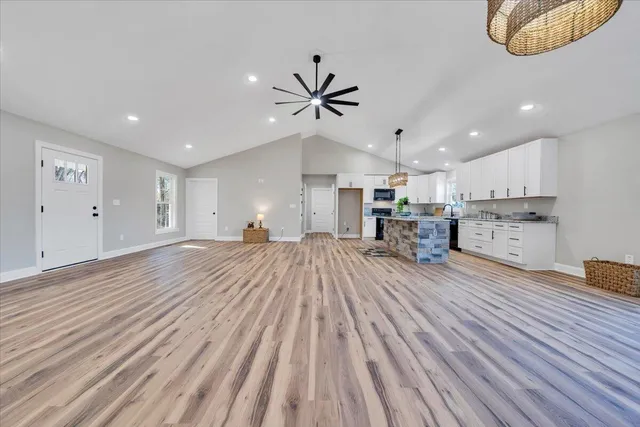 a view of empty room with wooden floor