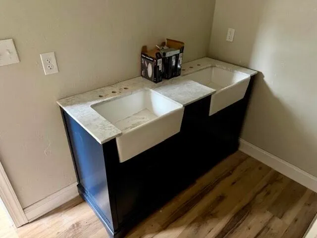 a kitchen with a sink cabinets and wooden floor
