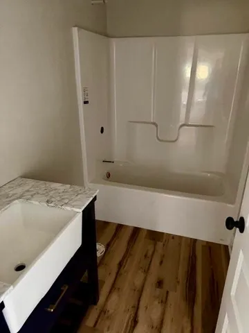 a bathroom with a bathtub and shower