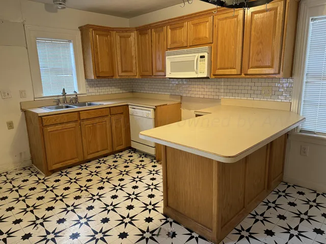 a kitchen with sink cabinets and window