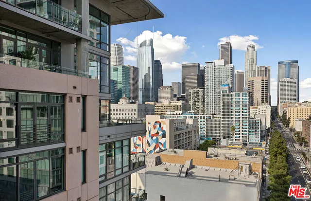 a view of city with balcony and tall buildings
