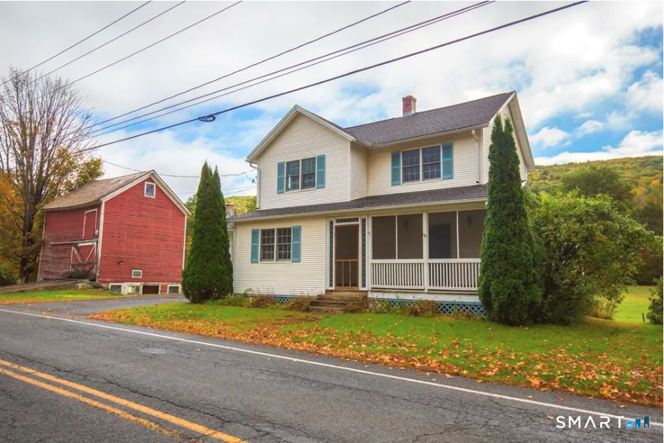 a front view of a house with a garden and yard