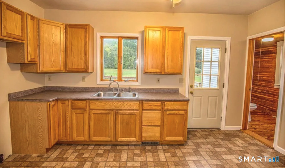 67 Middlefield Road Chester, MA 01011 - Photo 14 of 24 a view of a kitchen with granite countertop a sink and dishwasher with a large window