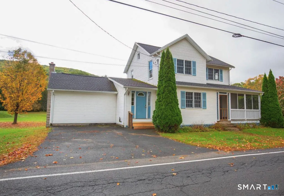 67 Middlefield Road Chester, MA 01011 - Photo 5 of 24 a front view of a house with a yard and garage