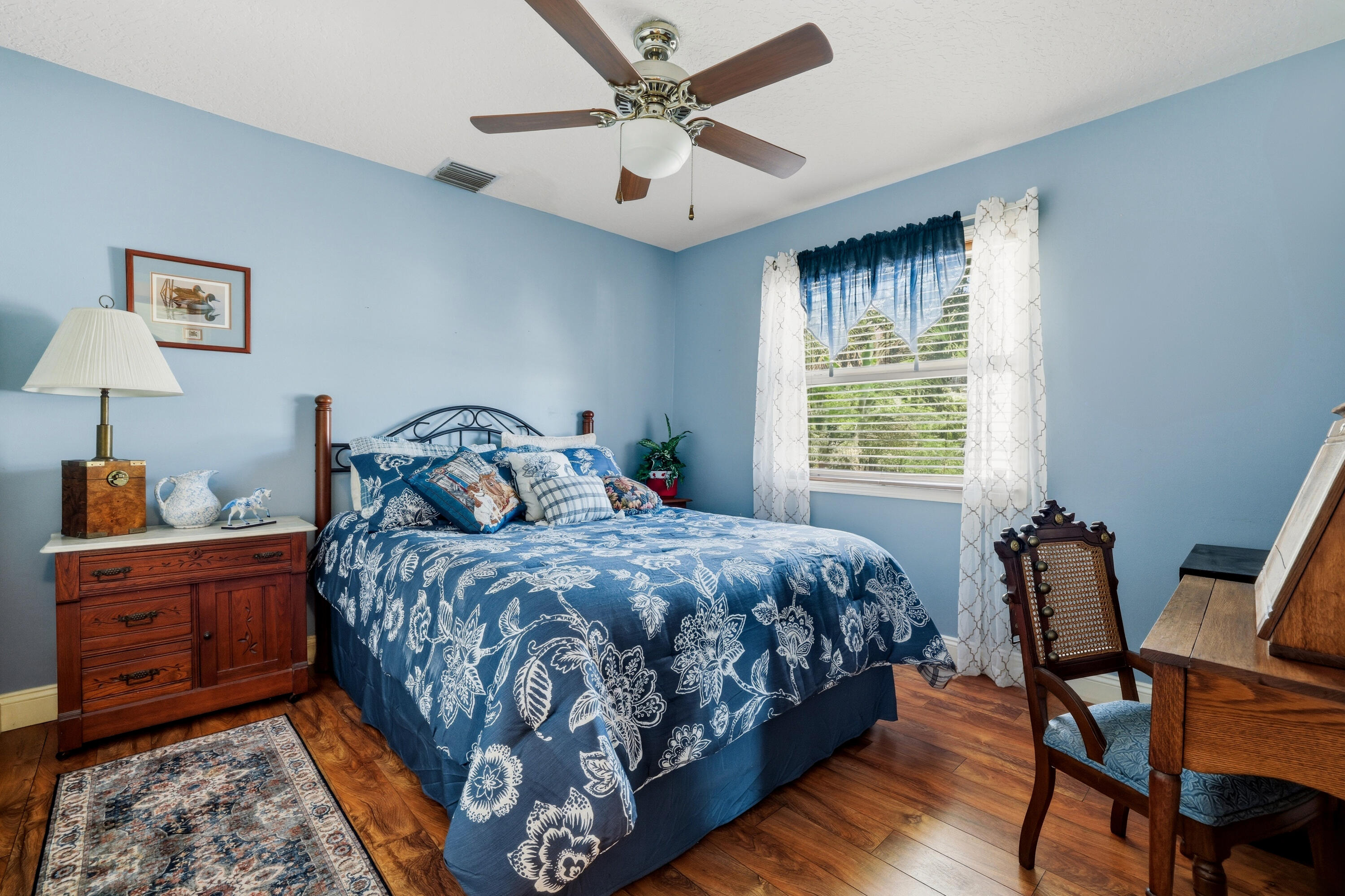 14095 Biddex Road Loxahatchee Groves, FL 33470 - Photo 24 of 69 a bedroom with a bed a chair and a large window