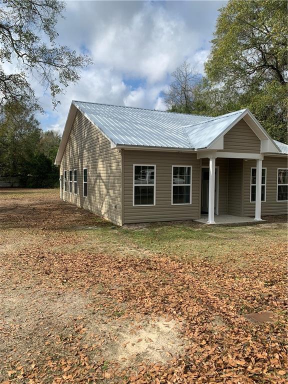 267 Saunders Street Southwest Pelham, GA 31779 - Photo 1 of 7 a backyard of a house with lots of green space