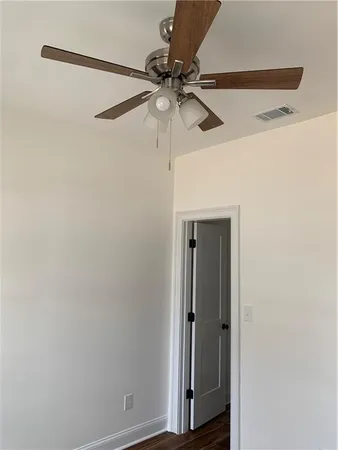 a view of a room with wooden floor and window