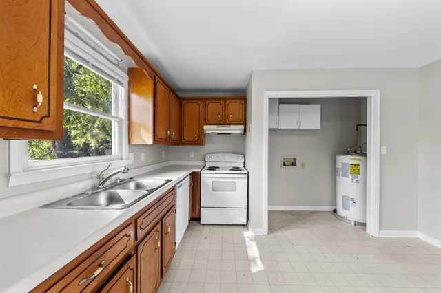 a kitchen with a sink stove and cabinets