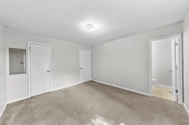 a view of an empty room and closet area
