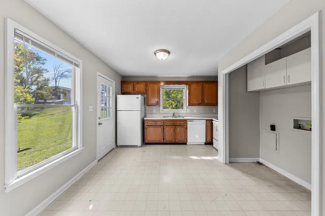 a kitchen with stainless steel appliances a refrigerator and a stove
