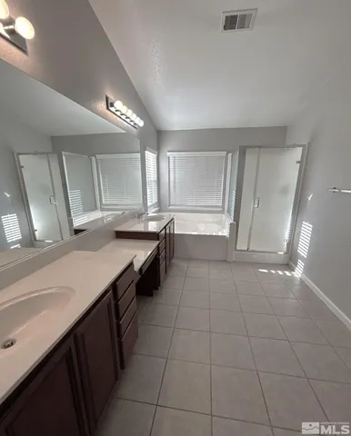 a large bathroom with a large tub and shower