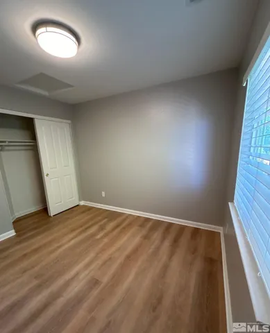 a spacious bathroom with a double vanity sink a mirror and a shower