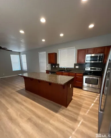 a large kitchen with stainless steel appliances