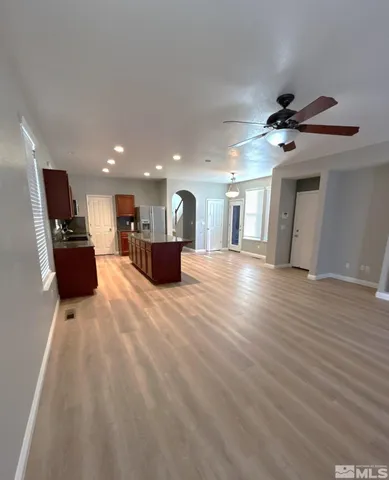 a view of a living room a kitchen and a wooden floor
