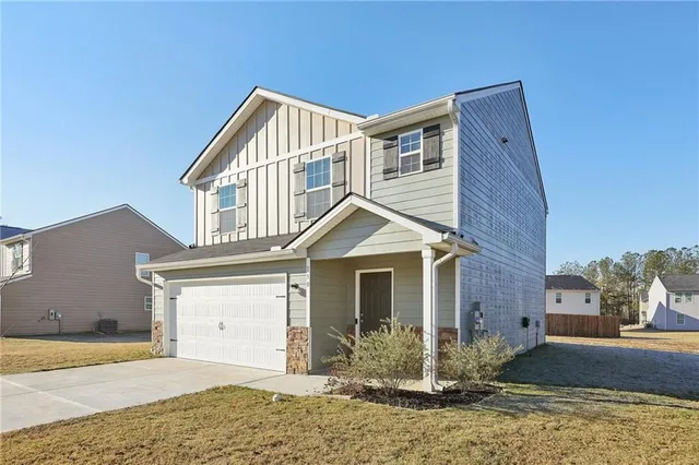 a front view of a house with a yard