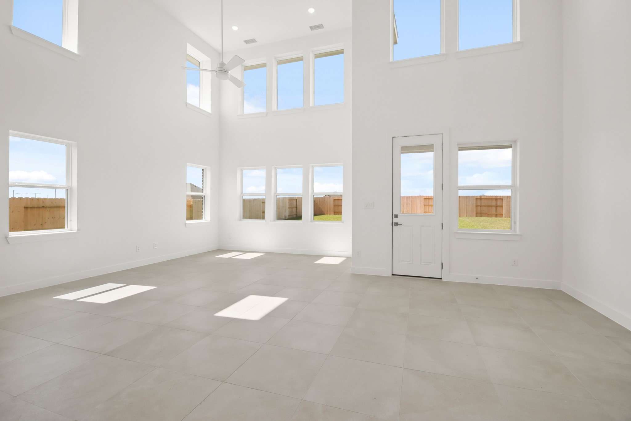 2810 Clapbread Lane Rosenberg, TX 77471 - Photo 6 of 39 an empty room with windows and chandelier fan