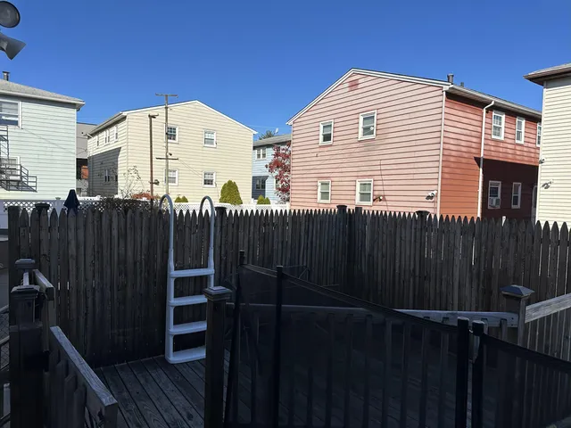 a view of a balcony with wooden fence