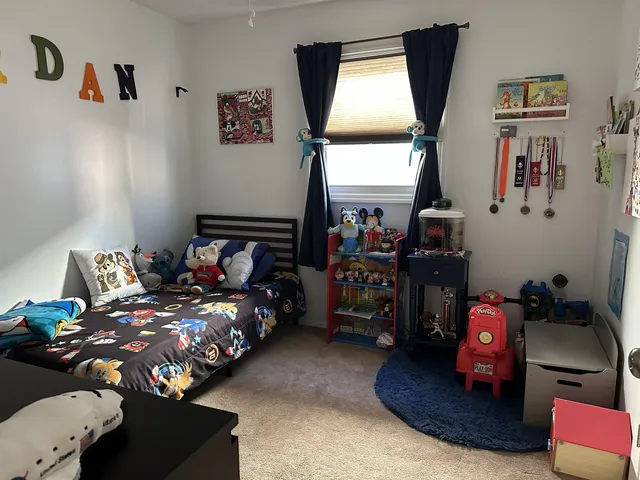 a bedroom with bed and a window