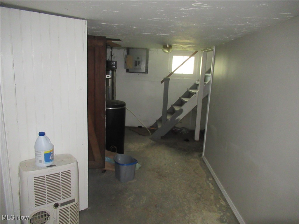 4482 Liberty Road Cleveland, OH 44121 - Photo 36 of 44 Below grade area featuring electric panel, stairway, and wooden walls