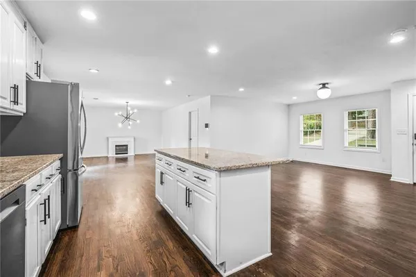 a kitchen with stainless steel appliances granite countertop a stove and a refrigerator