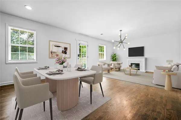 a view of a dining room with furniture and a flat screen tv