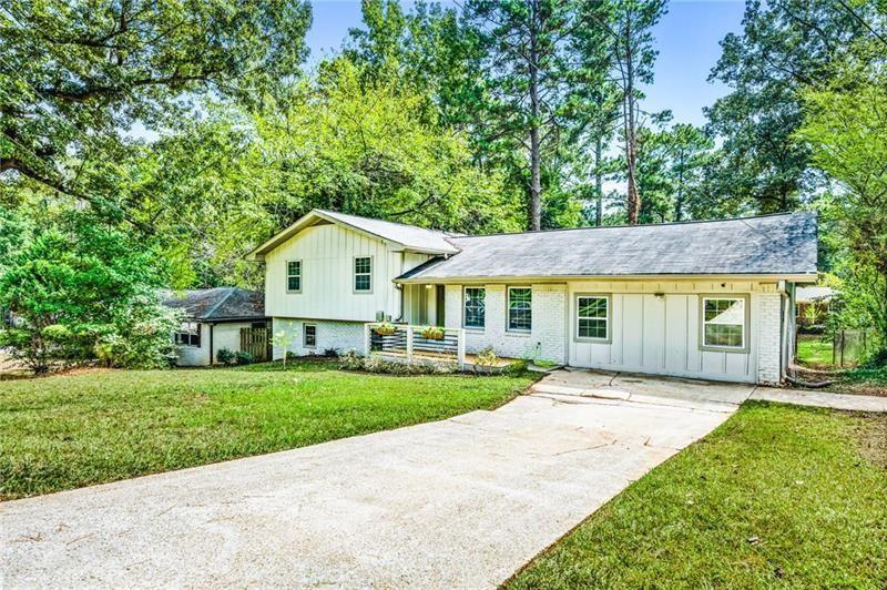 3089 Del Monico Drive Decatur, GA 30032 - Photo 2 of 47 a view of a white house with a big yard and large trees