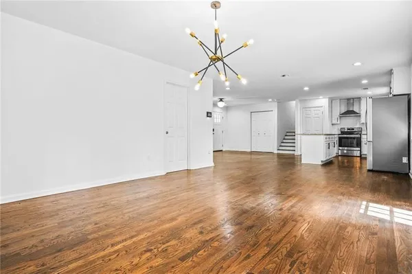 a view of a kitchen with a sink and a large window