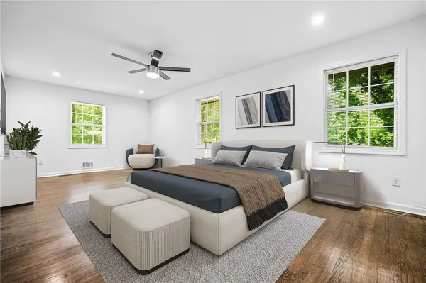 a bedroom with a large bed and a window