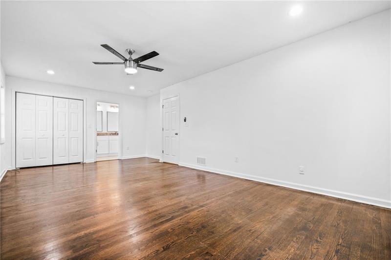 3089 Del Monico Drive Decatur, GA 30032 - Photo 27 of 47 an empty room with wooden floor ceiling fan and windows